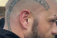 Majestätischer Wikinger: Ein Glatzkopf mit Runen-Tattoo, der die Essenz nordischer Stärke verkörpert